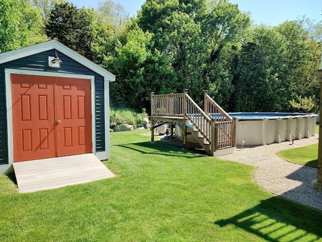 view of shed with an outdoor pool and stairs