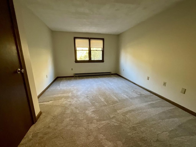 unfurnished room with light colored carpet and a baseboard radiator