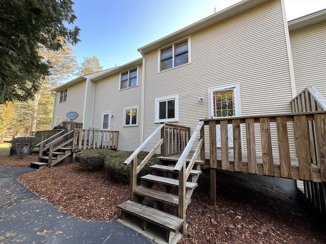 back of property featuring a deck