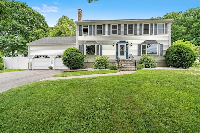 10 Manoogian Cir, Milford, MA 01757 - colonial-style house featuring a chimney, asphalt driveway, and a garage
