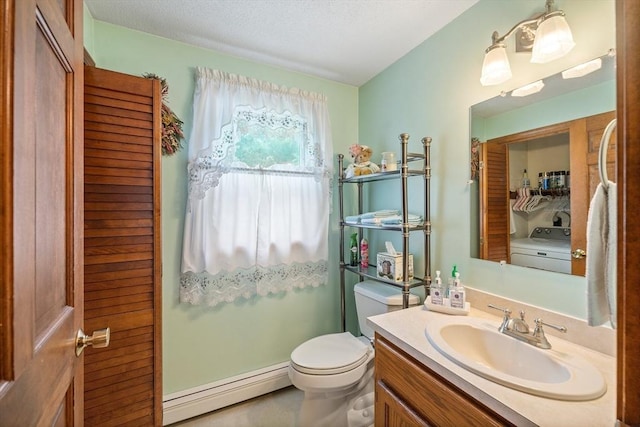 10 Manoogian Cir, Milford, MA 01757 - bathroom with baseboard heating, vanity, washer / clothes dryer, and a textured ceiling
