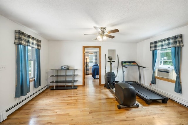 10 Manoogian Cir, Milford, MA 01757 - exercise area with a baseboard heating unit, light wood finished floors, cooling unit, ceiling fan, and a textured ceiling