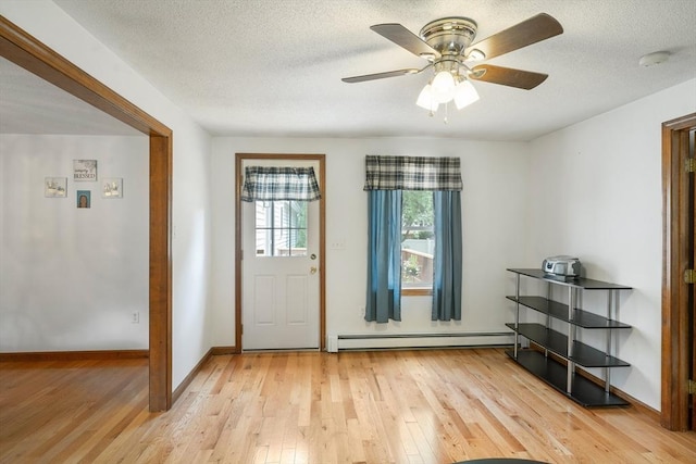 10 Manoogian Cir, Milford, MA 01757 - entrance foyer with baseboard heating, light wood-style flooring, a ceiling fan, and a textured ceiling