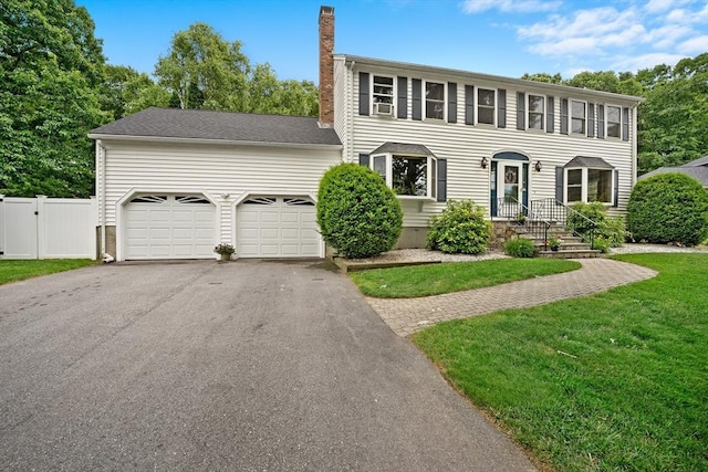 10 Manoogian Cir, Milford, MA 01757 - colonial home with a chimney, asphalt driveway, an attached garage, and a gate