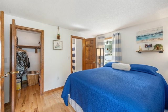 10 Manoogian Cir, Milford, MA 01757 - bedroom with light wood-style floors and a textured ceiling