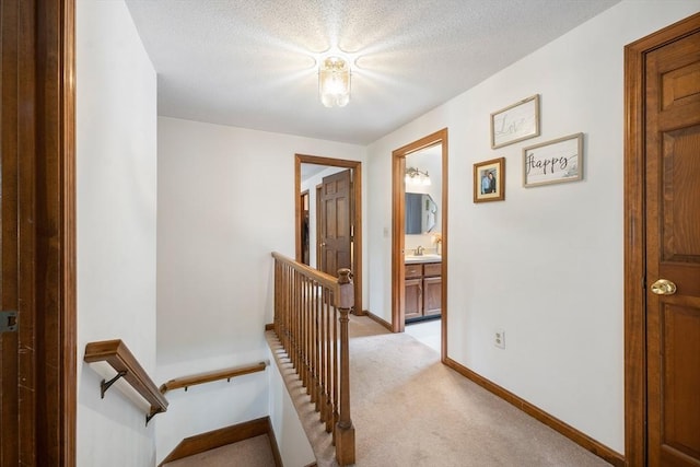 10 Manoogian Cir, Milford, MA 01757 - corridor featuring an upstairs landing, light colored carpet, and a textured ceiling
