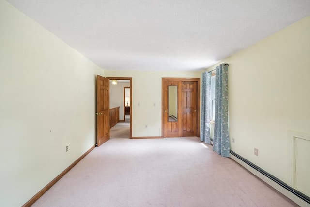 10 Manoogian Cir, Milford, MA 01757 - unfurnished room featuring a baseboard heating unit and light colored carpet