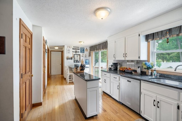 10 Manoogian Cir, Milford, MA 01757 - kitchen with dishwasher, white cabinetry, a textured ceiling, a center island, and light wood finished floors