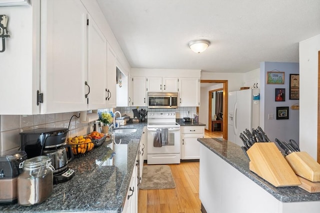 10 Manoogian Cir, Milford, MA 01757 - kitchen with white appliances, decorative backsplash, light wood-style floors, and white cabinetry