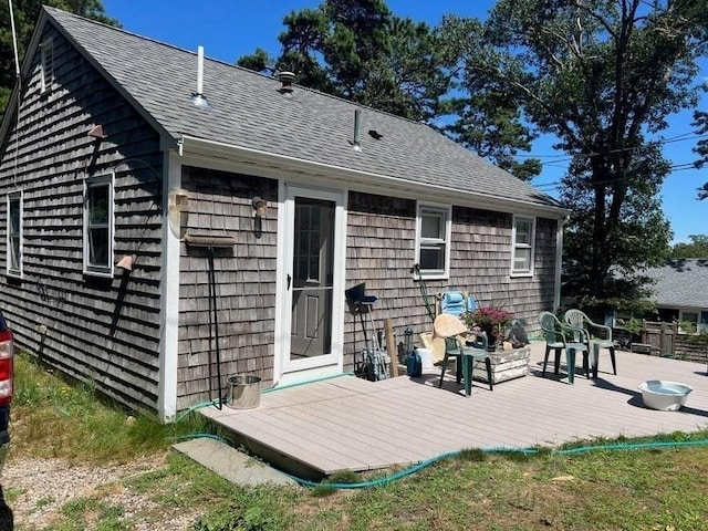 rear view of property featuring a wooden deck