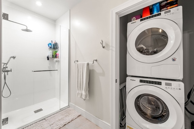 clothes washing area with stacked washer / dryer and tile floors