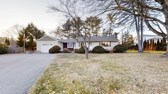 single story home featuring a garage and a front yard