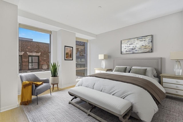 bedroom with baseboards and wood finished floors