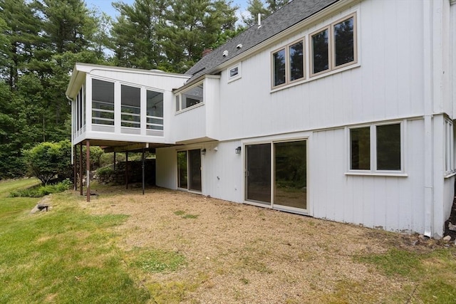 13 Long Ridge Rd, Acton, MA 01720 - back of property with a sunroom, a lawn, and a shingled roof