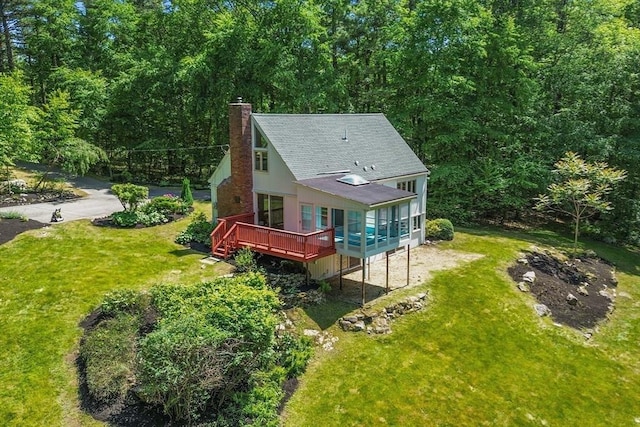 13 Long Ridge Rd, Acton, MA 01720 - back of property featuring a chimney, a deck, a shingled roof, a lawn, and a view of trees