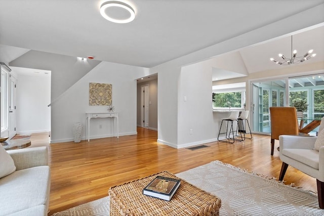 13 Long Ridge Rd, Acton, MA 01720 - living room with vaulted ceiling, a chandelier, and light wood finished floors