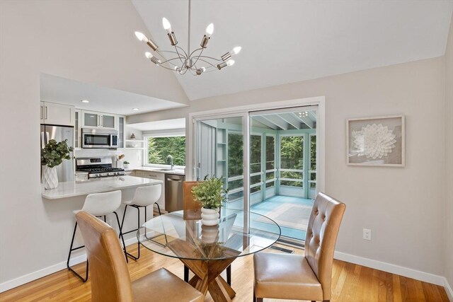13 Long Ridge Rd, Acton, MA 01720 - dining area featuring a chandelier, vaulted ceiling, and light wood-style flooring