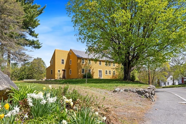 view of property exterior with a yard