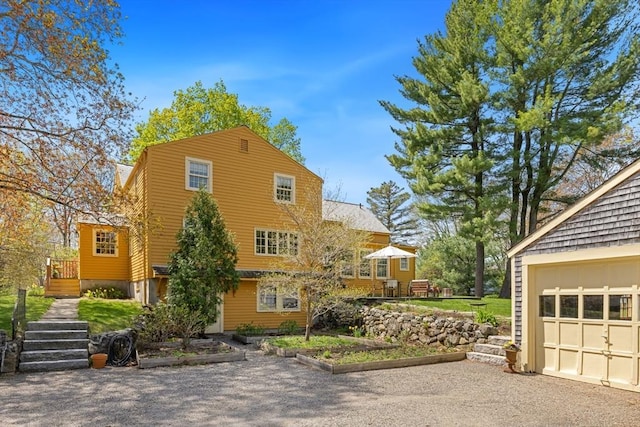 view of property exterior featuring stairs and a deck