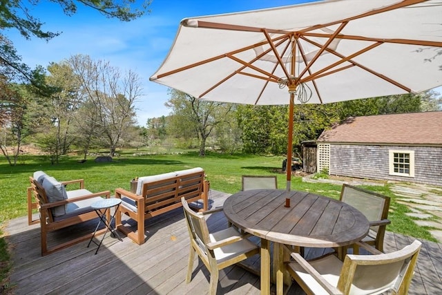 wooden deck with outdoor dining space and a yard