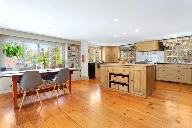 kitchen with open shelves, black dishwasher, a kitchen island, light wood-type flooring, and recessed lighting