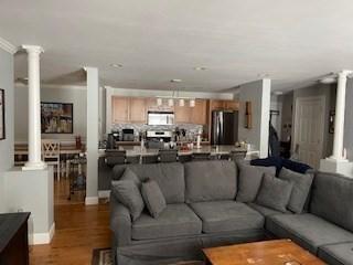 19 Broad St Unit 105, Merrimac, MA 01860 - living area featuring decorative columns and dark wood-type flooring