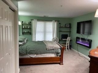 19 Broad St Unit 105, Merrimac, MA 01860 - carpeted bedroom with a glass covered fireplace and baseboards