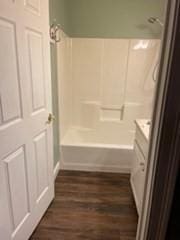 19 Broad St Unit 105, Merrimac, MA 01860 - bathroom featuring wood finished floors, shower / bath combination, and vanity
