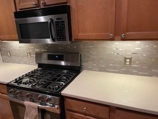 19 Broad St Unit 105, Merrimac, MA 01860 - kitchen featuring stainless steel appliances, tasteful backsplash, and light countertops