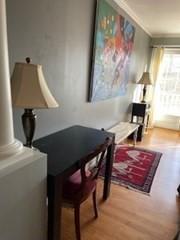19 Broad St Unit 105, Merrimac, MA 01860 - sitting room with decorative columns, wood finished floors, and ornamental molding