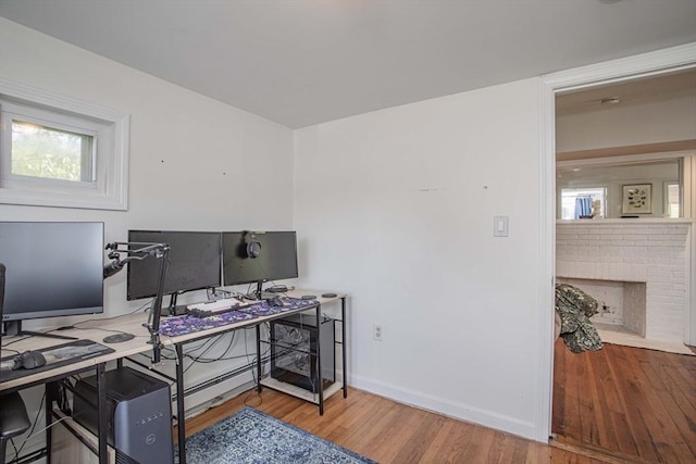 37 Raleigh Rd, Weymouth, MA 02189 - office with wood finished floors, baseboards, a brick fireplace, and plenty of natural light