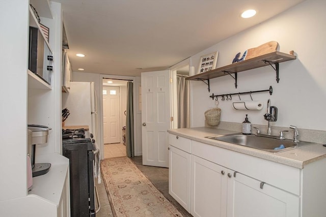 37 Raleigh Rd, Weymouth, MA 02189 - kitchen featuring gas range, a sink, white cabinetry, stainless steel microwave, and light countertops