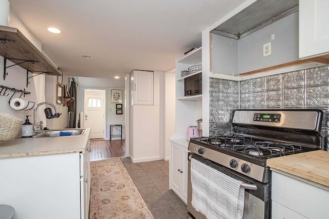 37 Raleigh Rd, Weymouth, MA 02189 - kitchen featuring stainless steel gas range oven, a sink, white cabinets, backsplash, and tile patterned floors