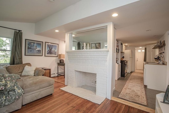 37 Raleigh Rd, Weymouth, MA 02189 - living area featuring wood finished floors, a fireplace, recessed lighting, and a baseboard radiator
