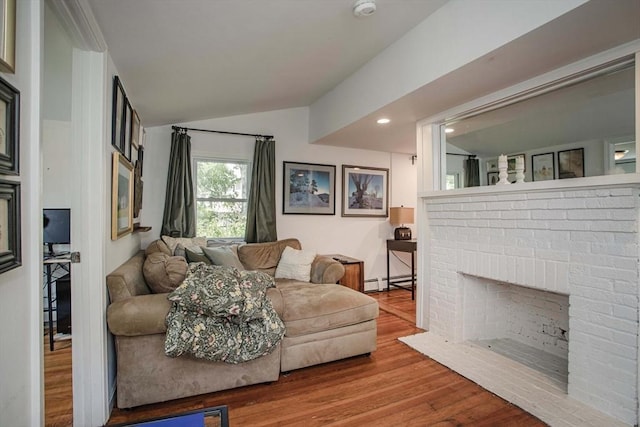 37 Raleigh Rd, Weymouth, MA 02189 - living area with vaulted ceiling, wood finished floors, a baseboard heating unit, a fireplace, and recessed lighting