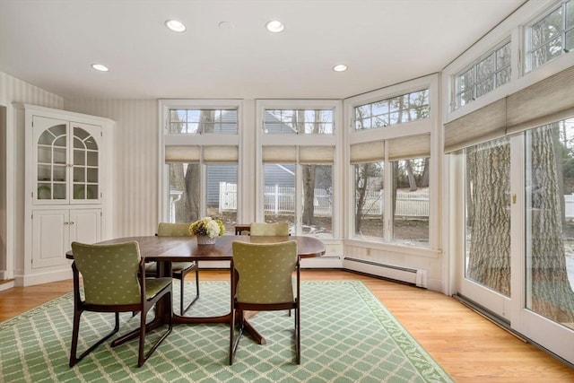 sunroom / solarium with a baseboard heating unit and a wealth of natural light