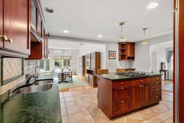 kitchen featuring decorative backsplash, stainless steel gas stovetop, open shelves, a sink, and recessed lighting