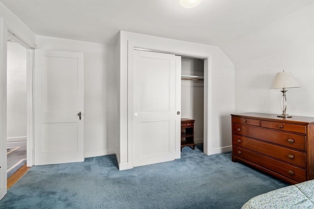 carpeted bedroom with baseboards, vaulted ceiling, and a closet