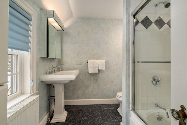 full bath featuring bath / shower combo with glass door, radiator heating unit, toilet, and baseboards