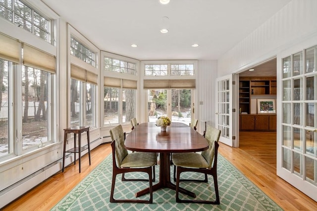 sunroom with french doors and a baseboard radiator