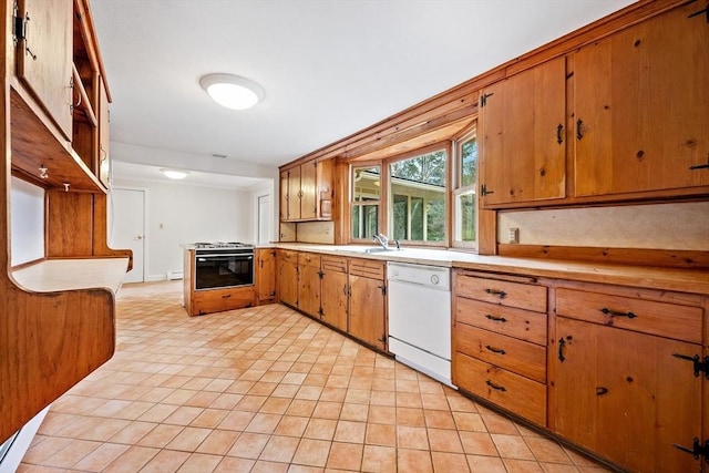 kitchen featuring brown cabinetry, dishwasher, a sink, light countertops, and gas stove