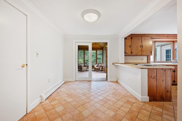 kitchen with light countertops, baseboards, crown molding, and a baseboard heating unit