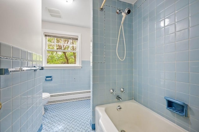 bathroom featuring shower / bathing tub combination, visible vents, tile walls, baseboard heating, and toilet