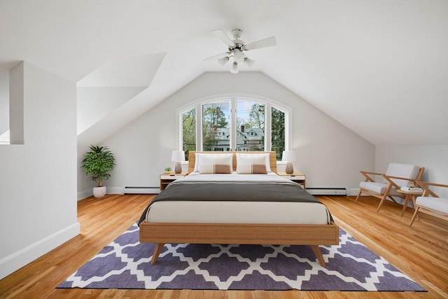 bedroom featuring ceiling fan, wood finished floors, vaulted ceiling, a baseboard radiator, and a baseboard heating unit