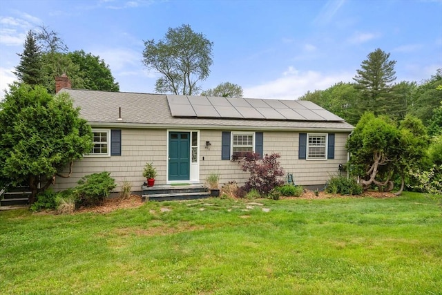 410 Central St, Acton, MA 01720 - ranch-style home featuring solar panels, a chimney, a front lawn, and roof with shingles