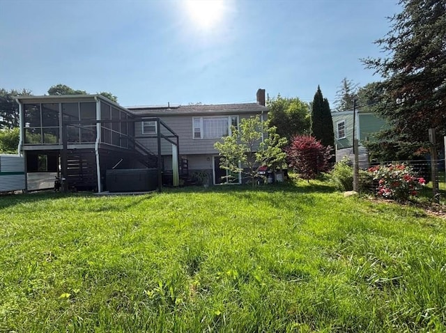 410 Central St, Acton, MA 01720 - back of property featuring a sunroom, a chimney, and a yard