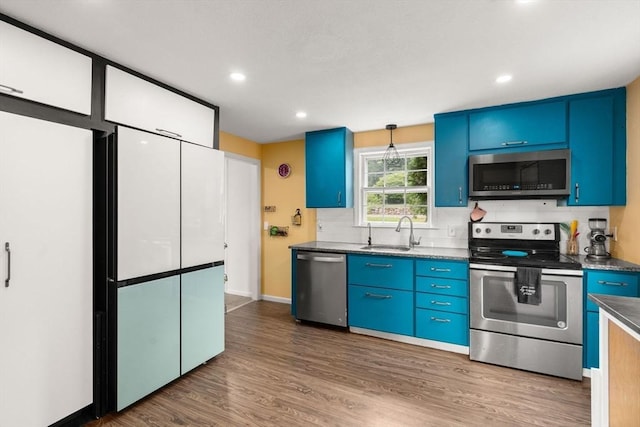 410 Central St, Acton, MA 01720 - kitchen featuring stainless steel appliances, blue cabinets, dark wood-style floors, recessed lighting, and dark countertops