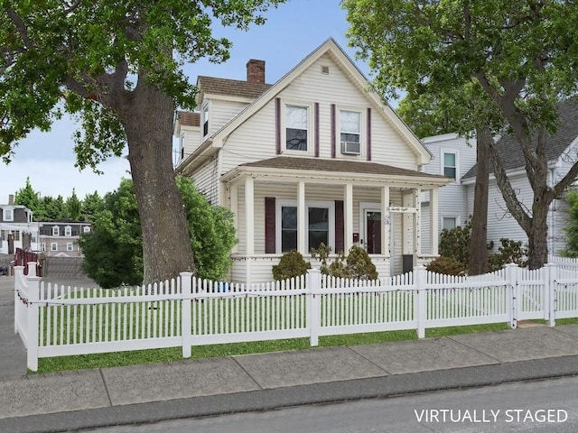 view of front of property with a fenced front yard, covered porch, a chimney, and a gate