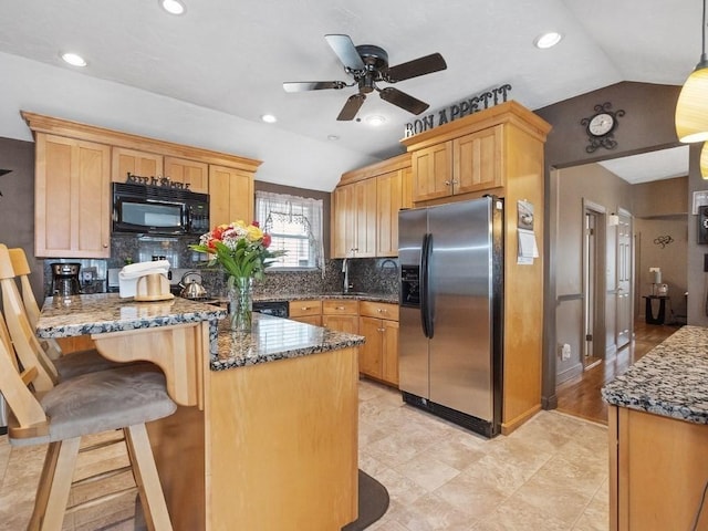 kitchen with stainless steel refrigerator with ice dispenser, tasteful backsplash, vaulted ceiling, dark stone countertops, and black microwave