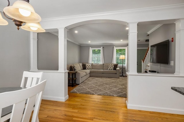 67 Madison St, Amesbury, MA 01913 - living area with decorative columns, wood finished floors, recessed lighting, ornamental molding, and arched walkways